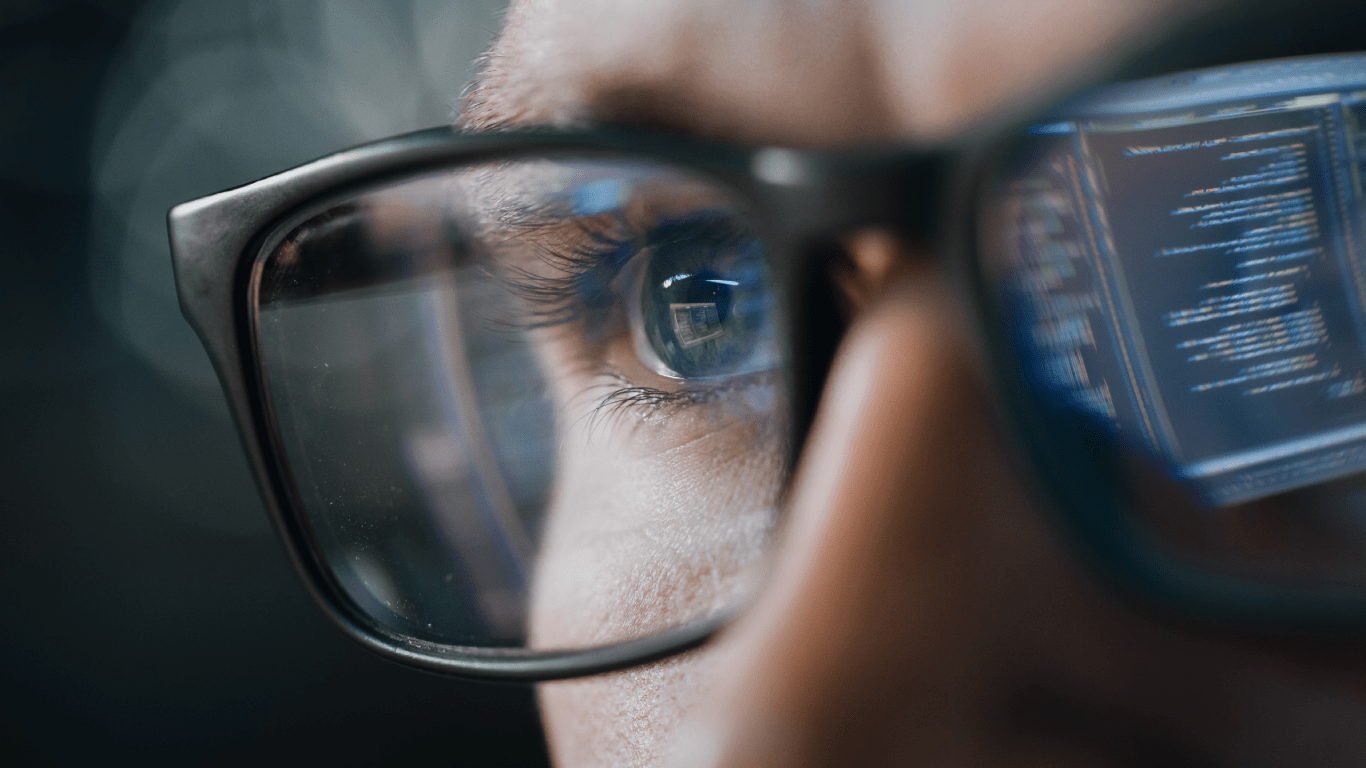 Close-up of a man's eyes behind glasses
